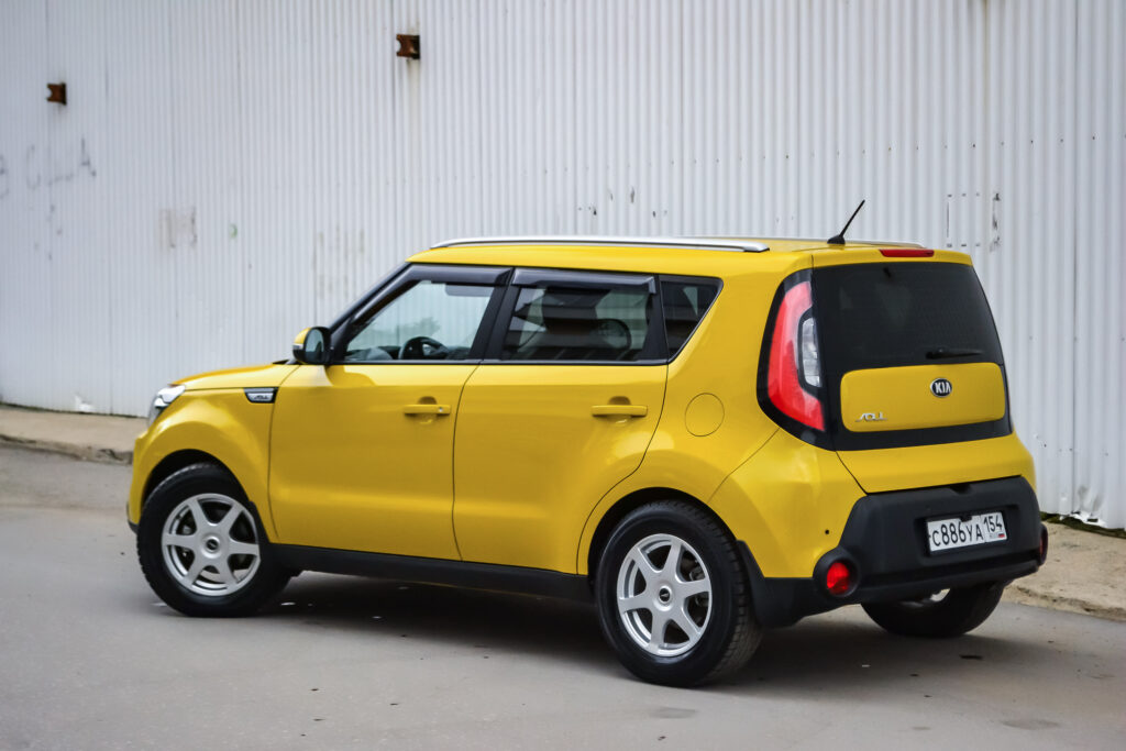 Novosibirsk, Russia - 05.26.2019: Rear view of used Kia Soul in yellow color after cleaning before sale in a summer day